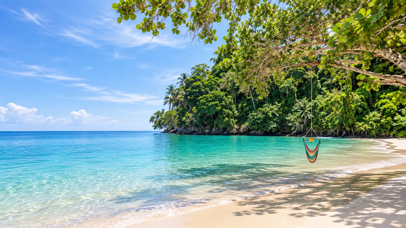 A turquoise bay at Punta Uva with a coloured hammock hanging from a tree