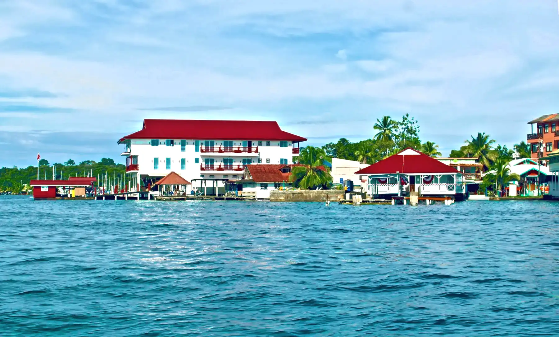 Red-roofed waterfront buildings across the water at Bocas del Toro, Panama