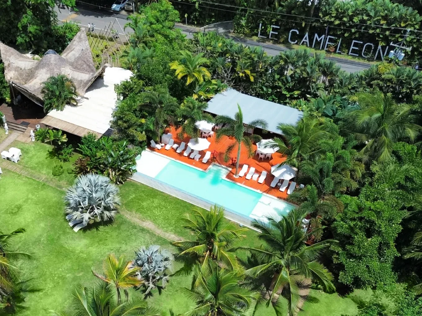 Aerial view of Le Caméléon Boutique Hotel on Playa Cocles, with its thatched pavilion