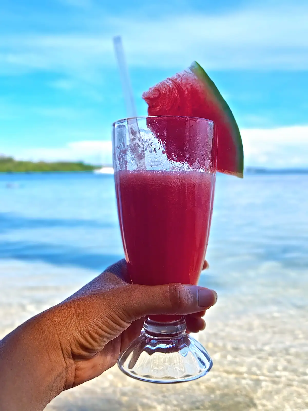 A watermelon smoothie held over the water near Almirante, Panama