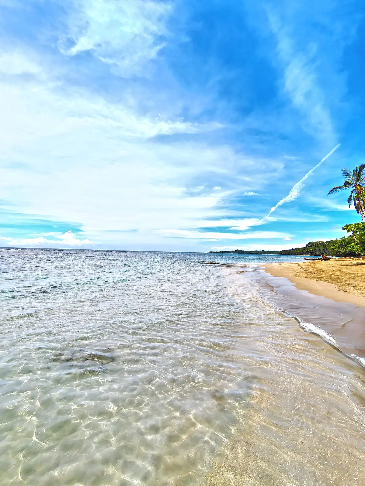Clear shallow water and a pale sand beach at Playa Chiquita