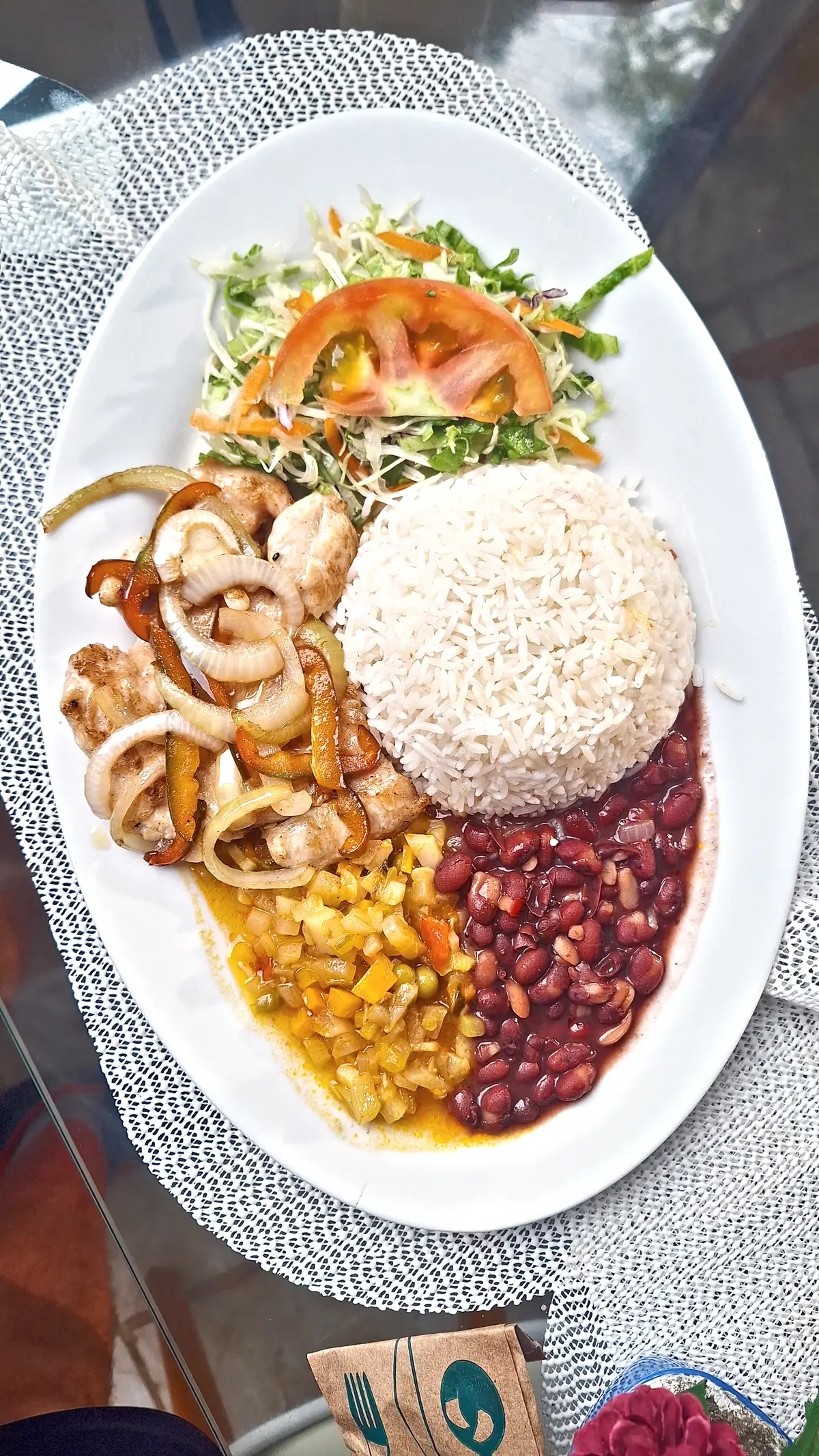 A plate of rice, beans, seafood and salad