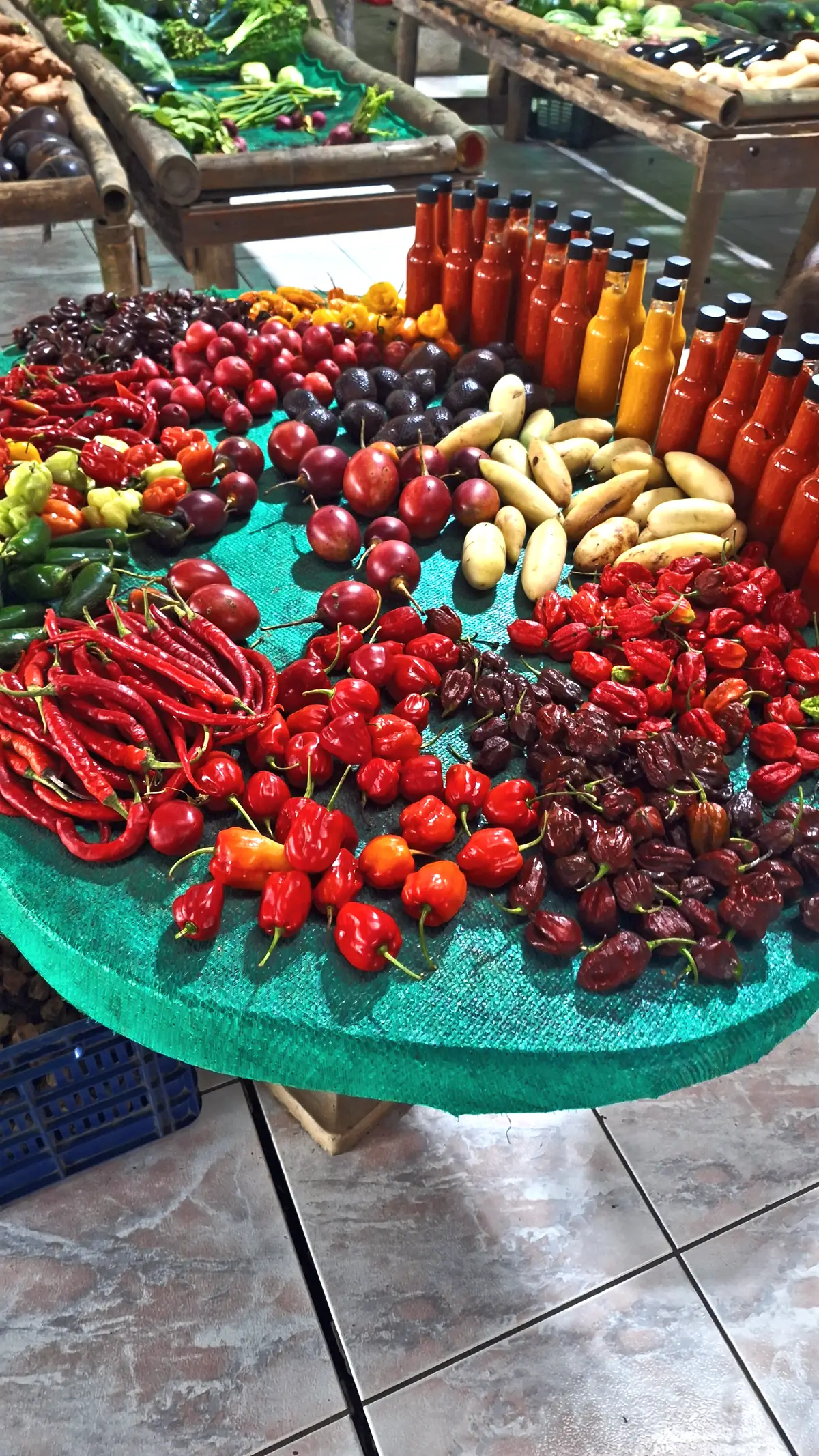 A market stall piled with chillies, tomatoes and bananas