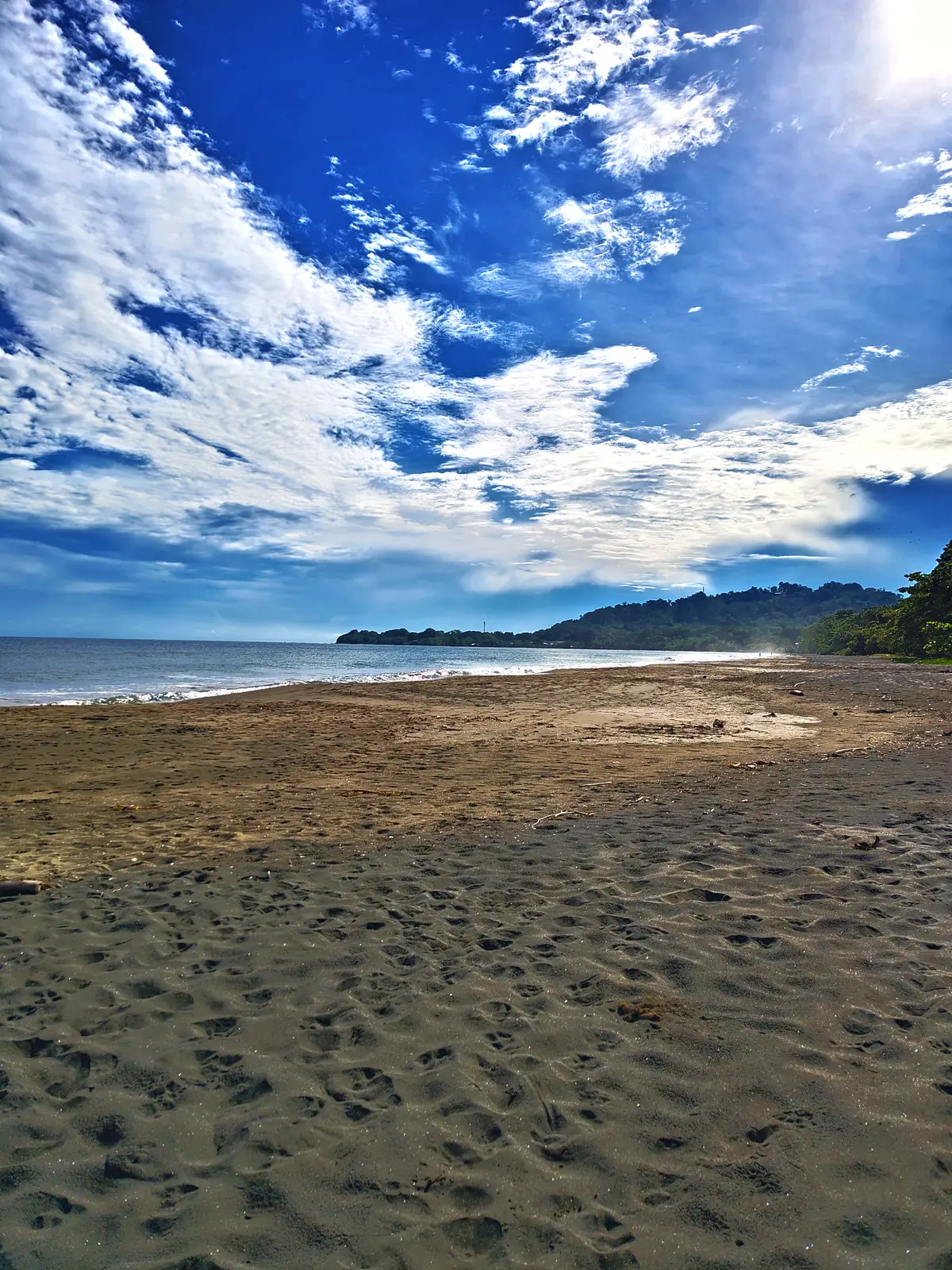 Dark sand and a bright sky at Playa Negra