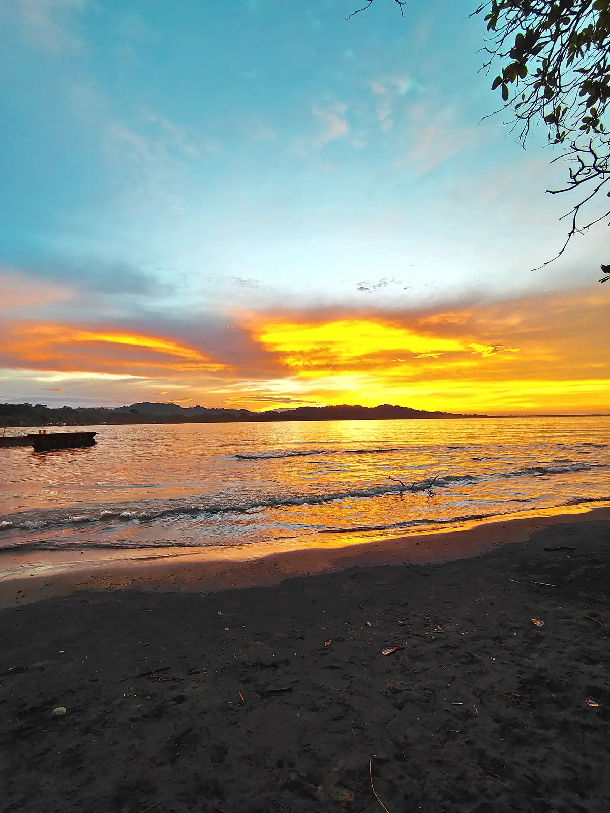 An orange sunset over the water at Puerto Viejo