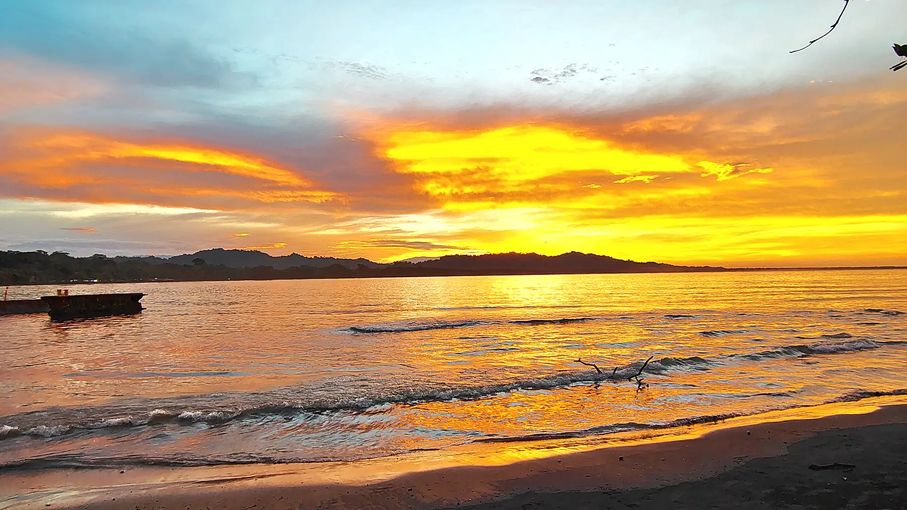 An orange sunset over the water at Puerto Viejo